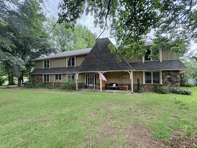 2412 S Camber Ave, Springfield, MO 65809 - view of front of house featuring stone siding, a front lawn, a patio area, and board and batten siding