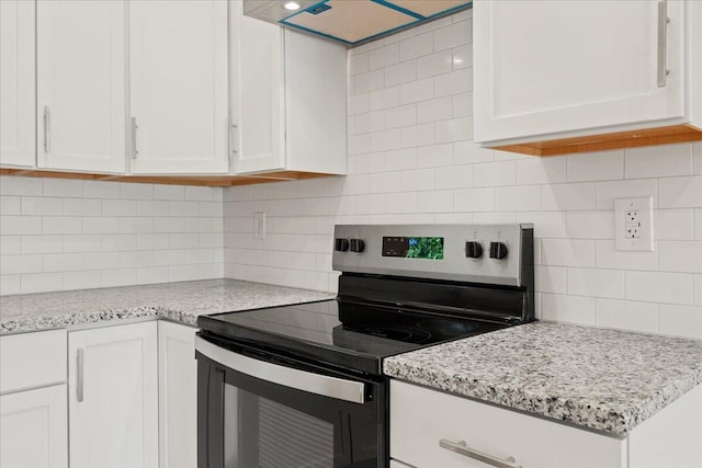 3001 E Colonial Ct, Republic, MO 65738 - kitchen featuring electric stove, extractor fan, decorative backsplash, white cabinetry, and light stone countertops