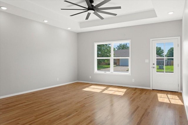 3001 E Colonial Ct, Republic, MO 65738 - unfurnished room featuring healthy amount of natural light, a raised ceiling, ceiling fan, light wood finished floors, and recessed lighting