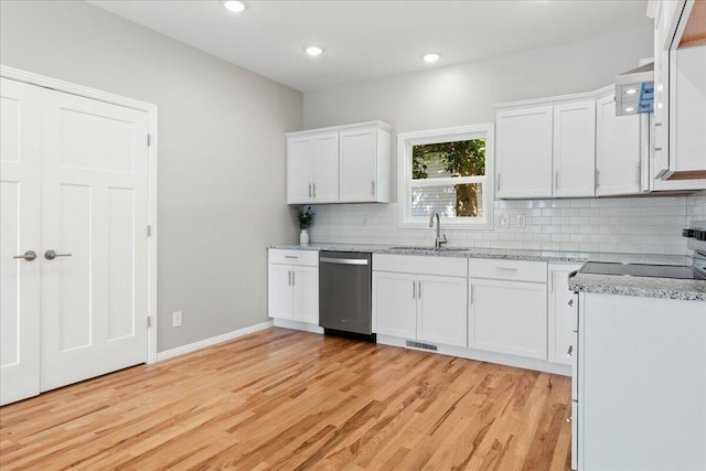 3001 E Colonial Ct, Republic, MO 65738 - kitchen featuring stainless steel dishwasher, light wood finished floors, tasteful backsplash, white cabinetry, and recessed lighting