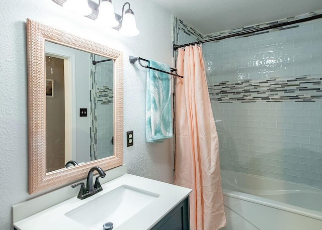 1050 S Glenn Ave, Springfield, MO 65802 - full bathroom featuring a textured wall, vanity, and shower / bathtub combination with curtain