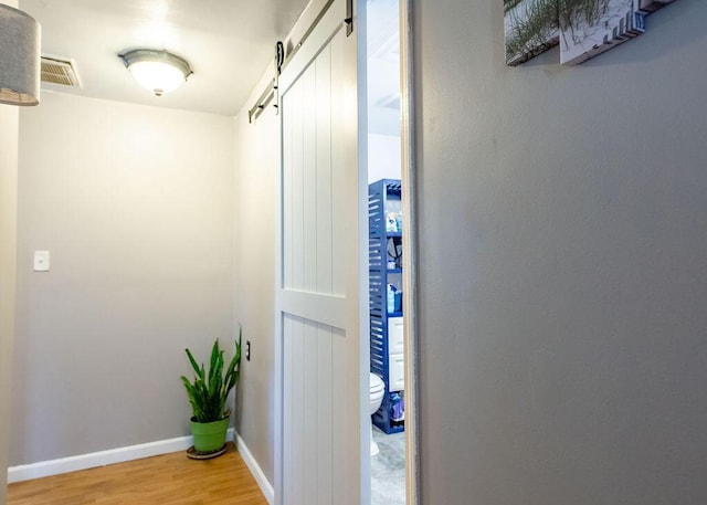 1050 S Glenn Ave, Springfield, MO 65802 - hallway with a barn door and light wood-style floors