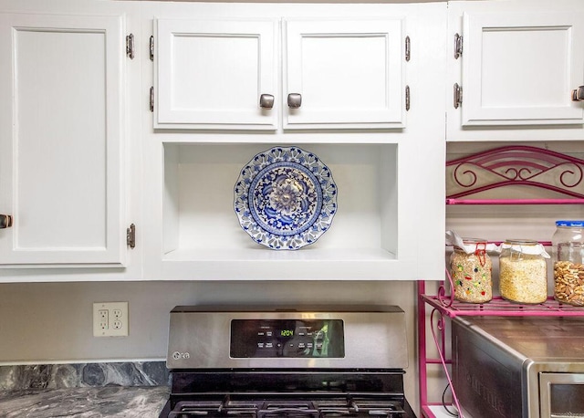 1050 S Glenn Ave, Springfield, MO 65802 - kitchen view of stainless steel stove and white cabinetry