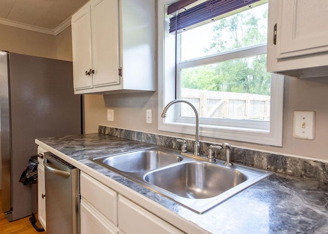 1050 S Glenn Ave, Springfield, MO 65802 - kitchen with crown molding, white cabinetry, dark countertops, and appliances with stainless steel finishes