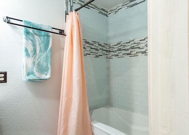 1050 S Glenn Ave, Springfield, MO 65802 - bathroom featuring shower / tub combo with curtain and a textured wall