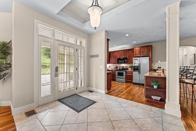 128 Mulligan Ct, Branson, MO 65616 - foyer entrance featuring decorative columns, light tile patterned floors, recessed lighting, and arched walkways