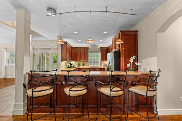 128 Mulligan Ct, Branson, MO 65616 - kitchen featuring refrigerator with ice dispenser, light stone countertops, a peninsula, pendant lighting, and recessed lighting