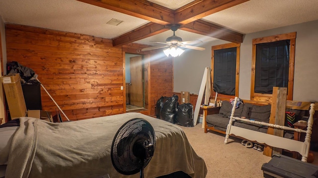 12 Riverbend Rd, Mammoth Spring, AR 72554 - bedroom with carpet floors, beamed ceiling, wooden walls, a textured ceiling, and a ceiling fan