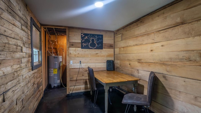 12 Riverbend Rd, Mammoth Spring, AR 72554 - dining area featuring electric water heater, wooden walls, and concrete flooring