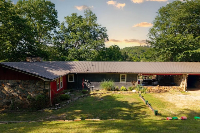 12 Riverbend Rd, Mammoth Spring, AR 72554 - single story home with stone siding, a metal roof, a lawn, and a chimney