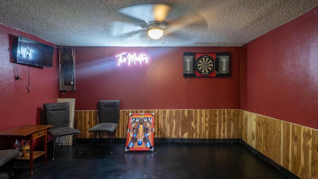 12 Riverbend Rd, Mammoth Spring, AR 72554 - cinema with a textured ceiling, wood walls, a wainscoted wall, and concrete floors