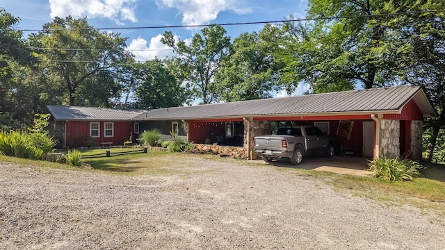 12 Riverbend Rd, Mammoth Spring, AR 72554 - ranch-style home with dirt driveway, an attached carport, stone siding, and a metal roof