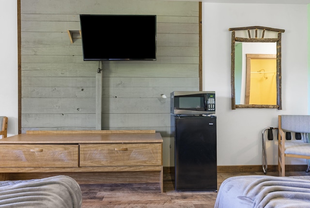 982 Indian Point Rd Unit 225, Indian Point, MO 65616 - bedroom with wood finished floors and wooden walls