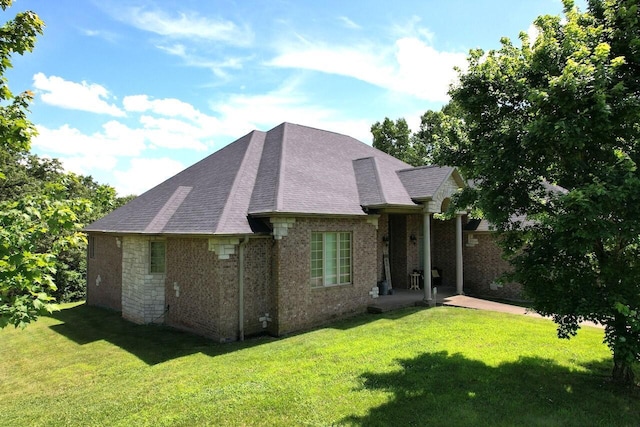 7876 County Road 3400, Mountain View, MO 65548 - back of house with a yard, roof with shingles, brick siding, and a patio area