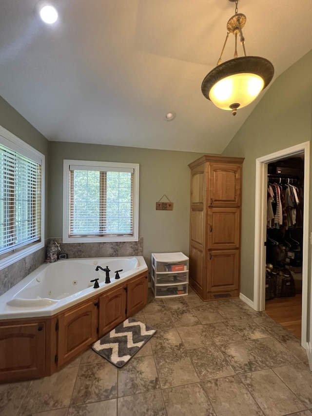 7876 County Road 3400, Mountain View, MO 65548 - full bathroom featuring a whirlpool tub, vaulted ceiling, and a spacious closet