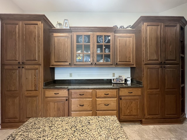 7876 County Road 3400, Mountain View, MO 65548 - kitchen featuring dark stone counters and glass insert cabinets