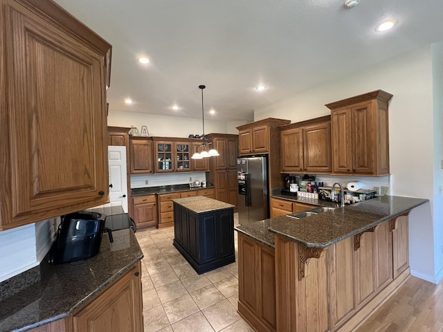 7876 County Road 3400, Mountain View, MO 65548 - kitchen with stainless steel refrigerator with ice dispenser, brown cabinetry, a peninsula, dark stone countertops, and glass insert cabinets