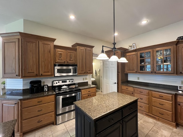 7876 County Road 3400, Mountain View, MO 65548 - kitchen featuring appliances with stainless steel finishes, glass insert cabinets, a center island, pendant lighting, and light tile patterned flooring