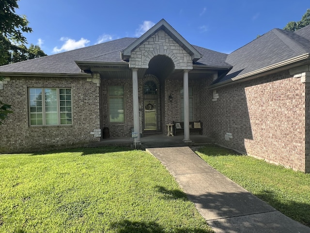 7876 County Road 3400, Mountain View, MO 65548 - view of front facade featuring a front lawn, brick siding, a shingled roof, and a porch