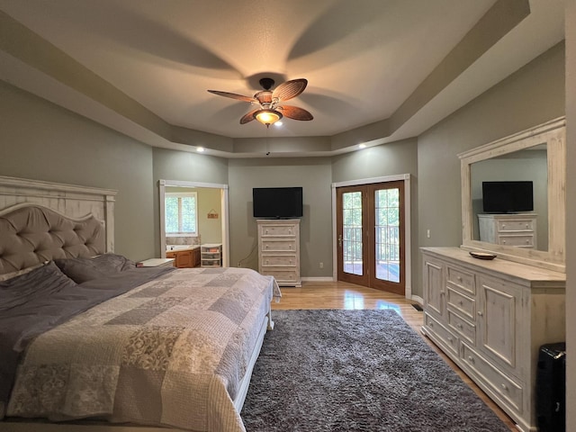 7876 County Road 3400, Mountain View, MO 65548 - bedroom with access to outside, a tray ceiling, light wood-style flooring, and ceiling fan