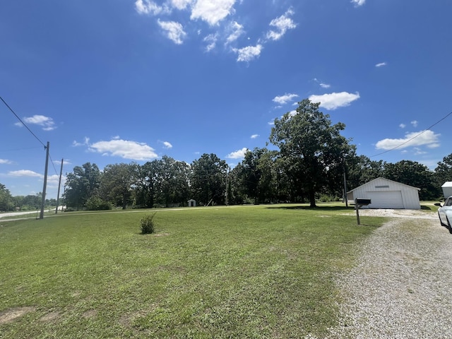 2039 US Highway 65, Buffalo, MO 65622 - view of grassy yard with a detached garage, gravel driveway, and an outbuilding