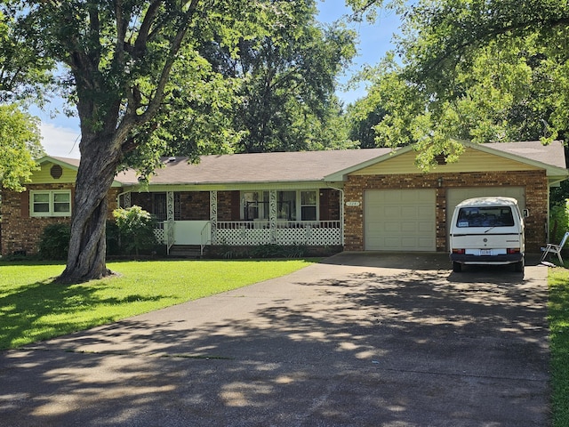 224 Crawford St, West Plains, MO 65775 - ranch-style house featuring a front lawn, an attached garage, driveway, and brick siding