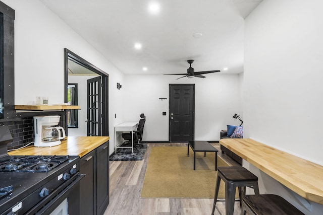 3430 S Elmview Ave, Springfield, MO 65804 - kitchen featuring butcher block countertops, black range with gas stovetop, light wood-style floors, recessed lighting, and a ceiling fan