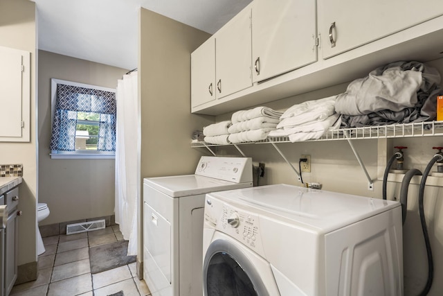 3430 S Elmview Ave, Springfield, MO 65804 - washroom featuring cabinet space, washing machine and clothes dryer, and light tile patterned floors