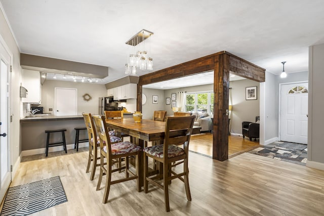 3430 S Elmview Ave, Springfield, MO 65804 - dining space featuring light wood finished floors and a chandelier