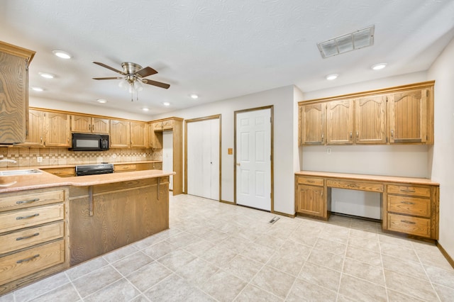 5751 S Kings Ave, Springfield, MO 65810 - kitchen with black microwave, stove, a ceiling fan, tasteful backsplash, and recessed lighting