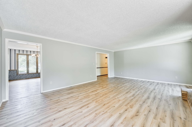 5751 S Kings Ave, Springfield, MO 65810 - spare room featuring a textured ceiling, light wood-style floors, crown molding, and a chandelier