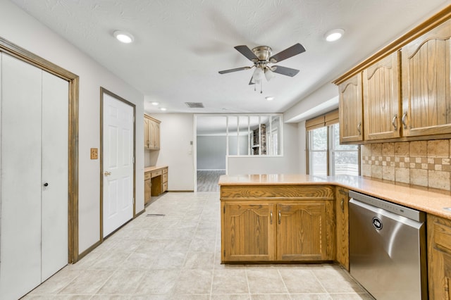 5751 S Kings Ave, Springfield, MO 65810 - kitchen featuring dishwasher, a peninsula, a ceiling fan, light countertops, and decorative backsplash