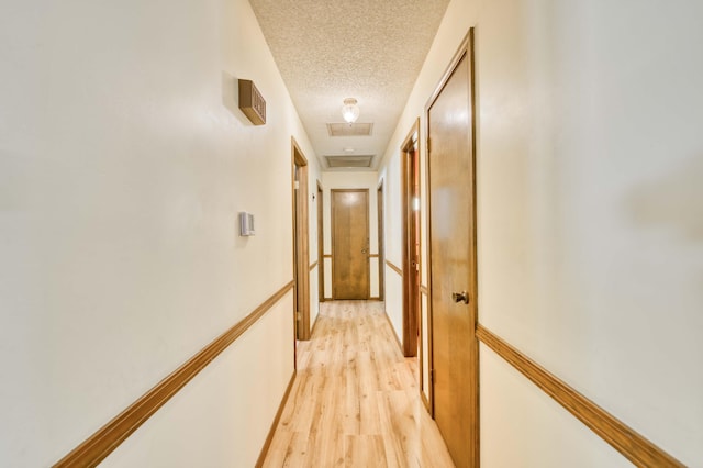 5751 S Kings Ave, Springfield, MO 65810 - hallway featuring a textured ceiling and light wood-style floors