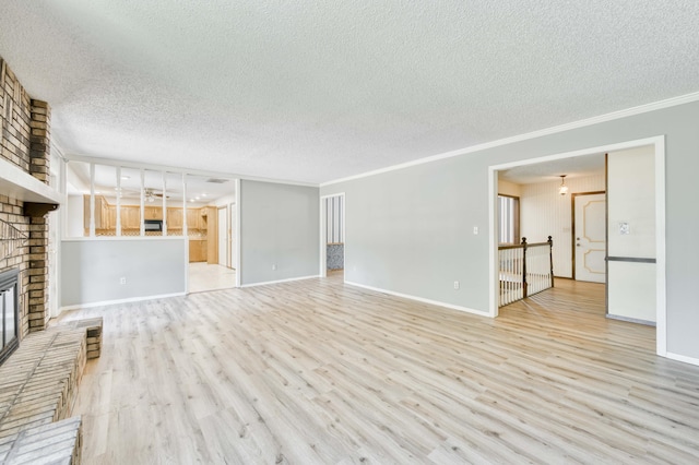5751 S Kings Ave, Springfield, MO 65810 - unfurnished living room featuring a textured ceiling, a brick fireplace, wood finished floors, and crown molding