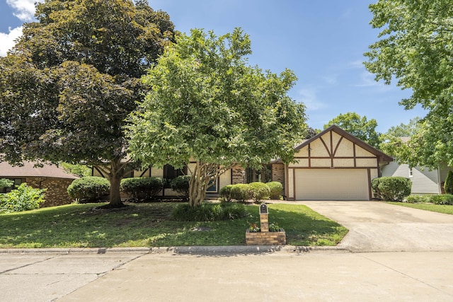 5751 S Kings Ave, Springfield, MO 65810 - view of front facade with an attached garage, concrete driveway, a front lawn, and stucco siding