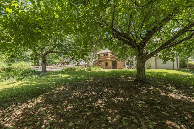 5751 S Kings Ave, Springfield, MO 65810 - view of yard with a wooden deck, a garage, and stairs