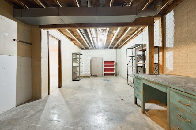5751 S Kings Ave, Springfield, MO 65810 - unfinished below grade area featuring brick wall and a workshop area