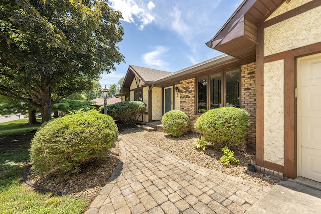 5751 S Kings Ave, Springfield, MO 65810 - view of property exterior featuring a garage and brick siding