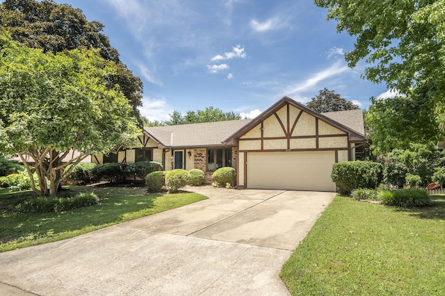 5751 S Kings Ave, Springfield, MO 65810 - view of front facade featuring an attached garage, a front yard, concrete driveway, stucco siding, and roof with shingles
