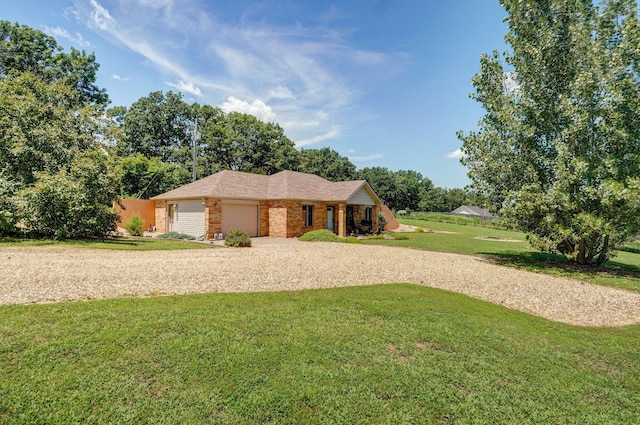 1360 Johnson Rd, Sparta, MO 65753 - view of front of home with brick siding, gravel driveway, a front yard, and a garage