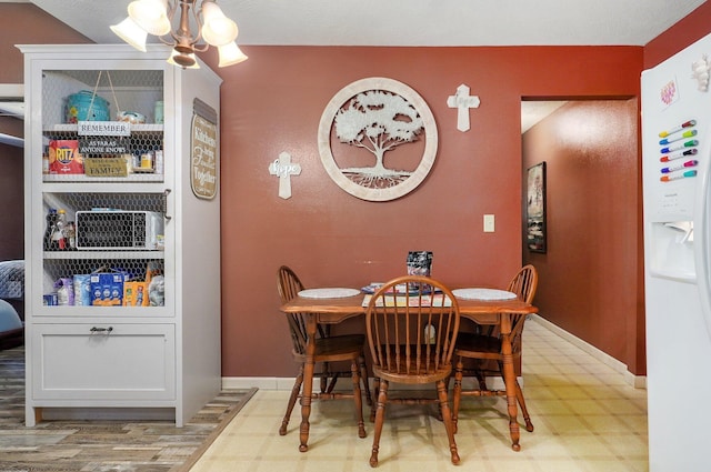1360 Johnson Rd, Sparta, MO 65753 - dining area featuring tile patterned floors and a chandelier