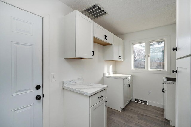 502 S Walnut St, Walnut Grove, MO 65770 - laundry room with dark wood-style floors and a textured ceiling