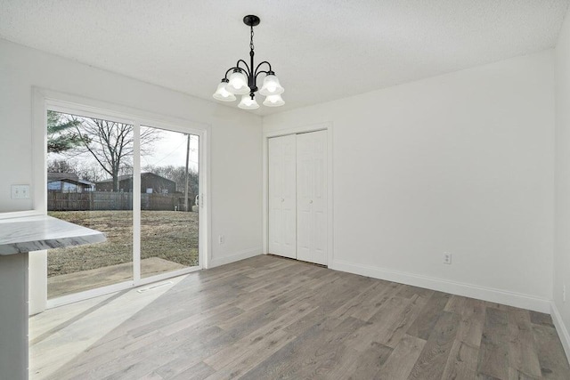 502 S Walnut St, Walnut Grove, MO 65770 - unfurnished dining area with a chandelier and wood finished floors
