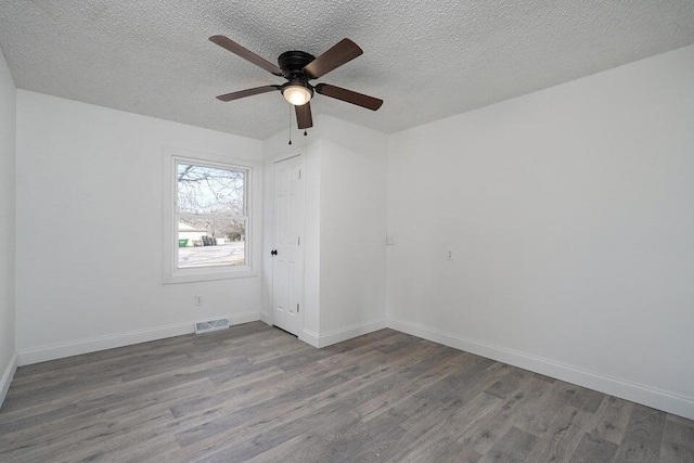 502 S Walnut St, Walnut Grove, MO 65770 - empty room featuring wood finished floors, ceiling fan, and a textured ceiling