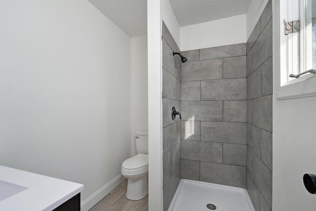 502 S Walnut St, Walnut Grove, MO 65770 - full bath featuring vanity, wood finished floors, a tile shower, and a textured ceiling