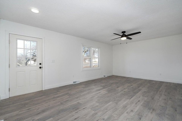502 S Walnut St, Walnut Grove, MO 65770 - spare room with wood finished floors, ceiling fan, and a textured ceiling