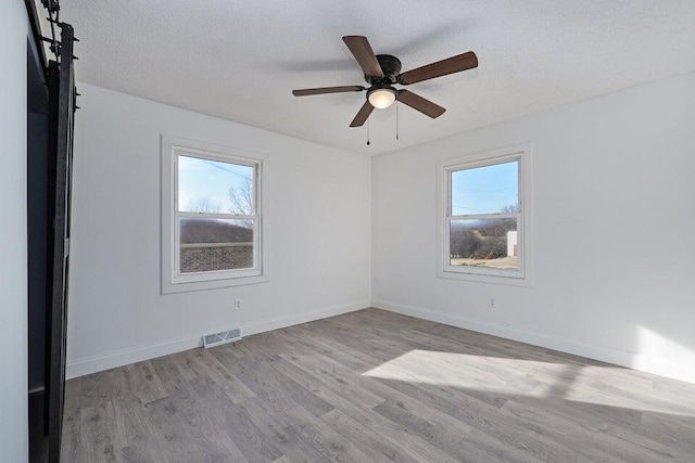 502 S Walnut St, Walnut Grove, MO 65770 - spare room with healthy amount of natural light, wood finished floors, and ceiling fan