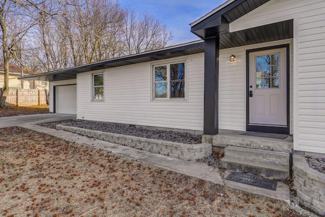 502 S Walnut St, Walnut Grove, MO 65770 - property entrance featuring an attached garage and concrete driveway