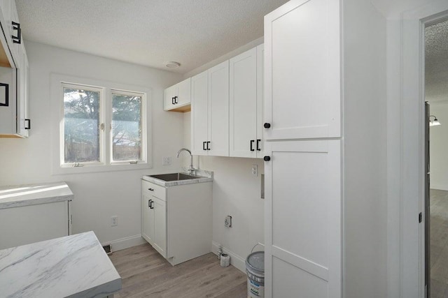 502 S Walnut St, Walnut Grove, MO 65770 - washroom with light wood-style flooring and a textured ceiling