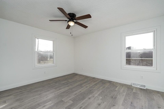 502 S Walnut St, Walnut Grove, MO 65770 - unfurnished room with wood finished floors, ceiling fan, and a textured ceiling